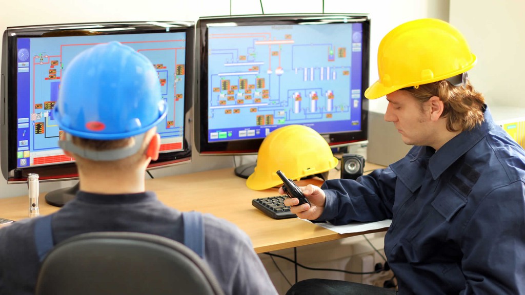 Operators in control room coomunicating manual valve positions