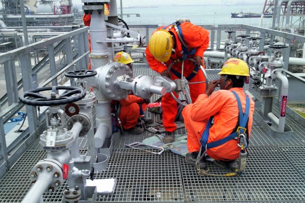 Service engineers installing valve interlocks